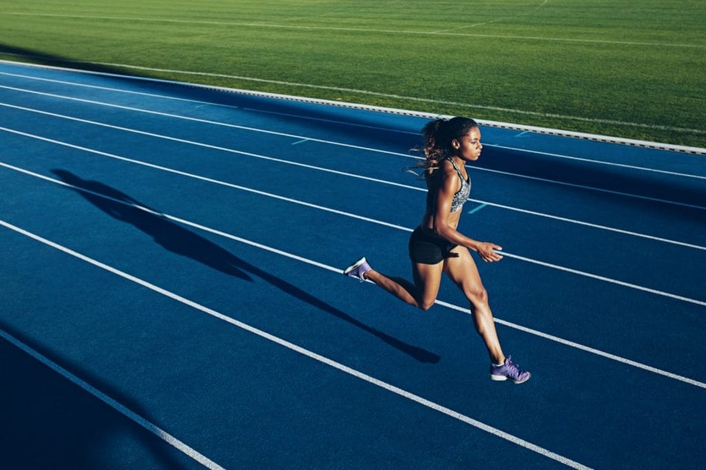 Woman running along on a track