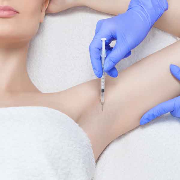 Woman receiving botox injection in armpit