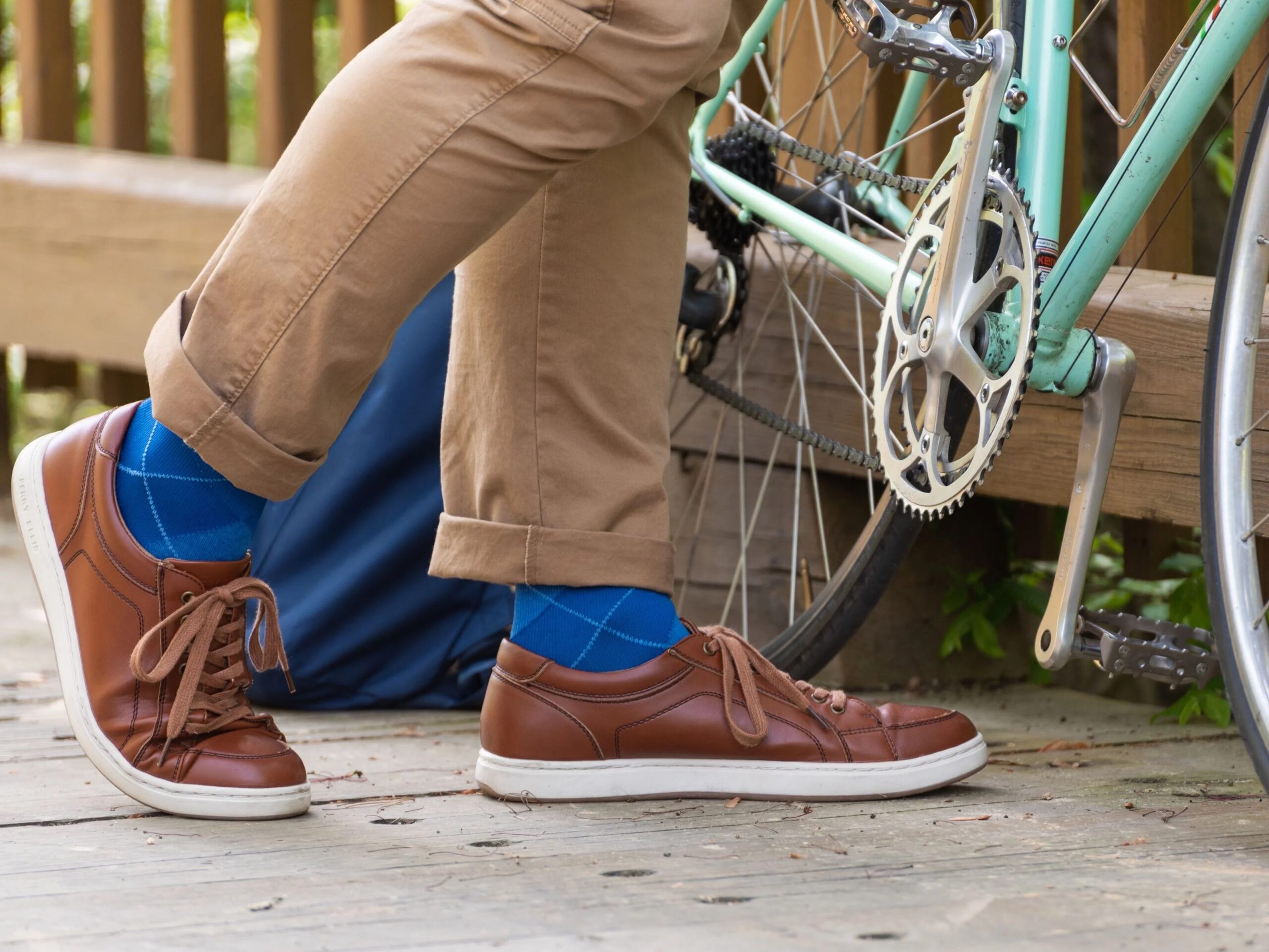 Close up of man wearing shoes about to ride a bike